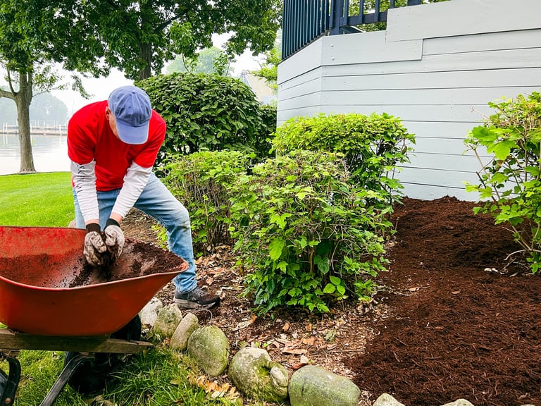 Landscaping professional unloading mulch in beautiful yard